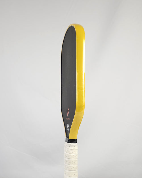 Pickleball paddle with yellow metallic edge tape