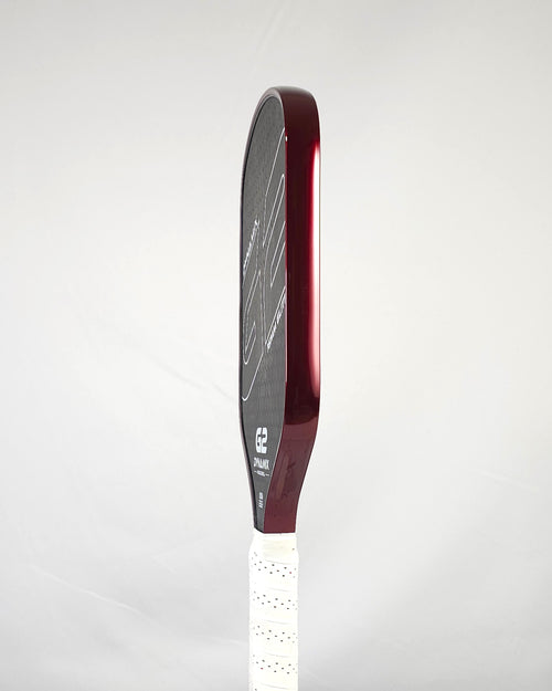 Pickleball paddle with red metallic edge tape