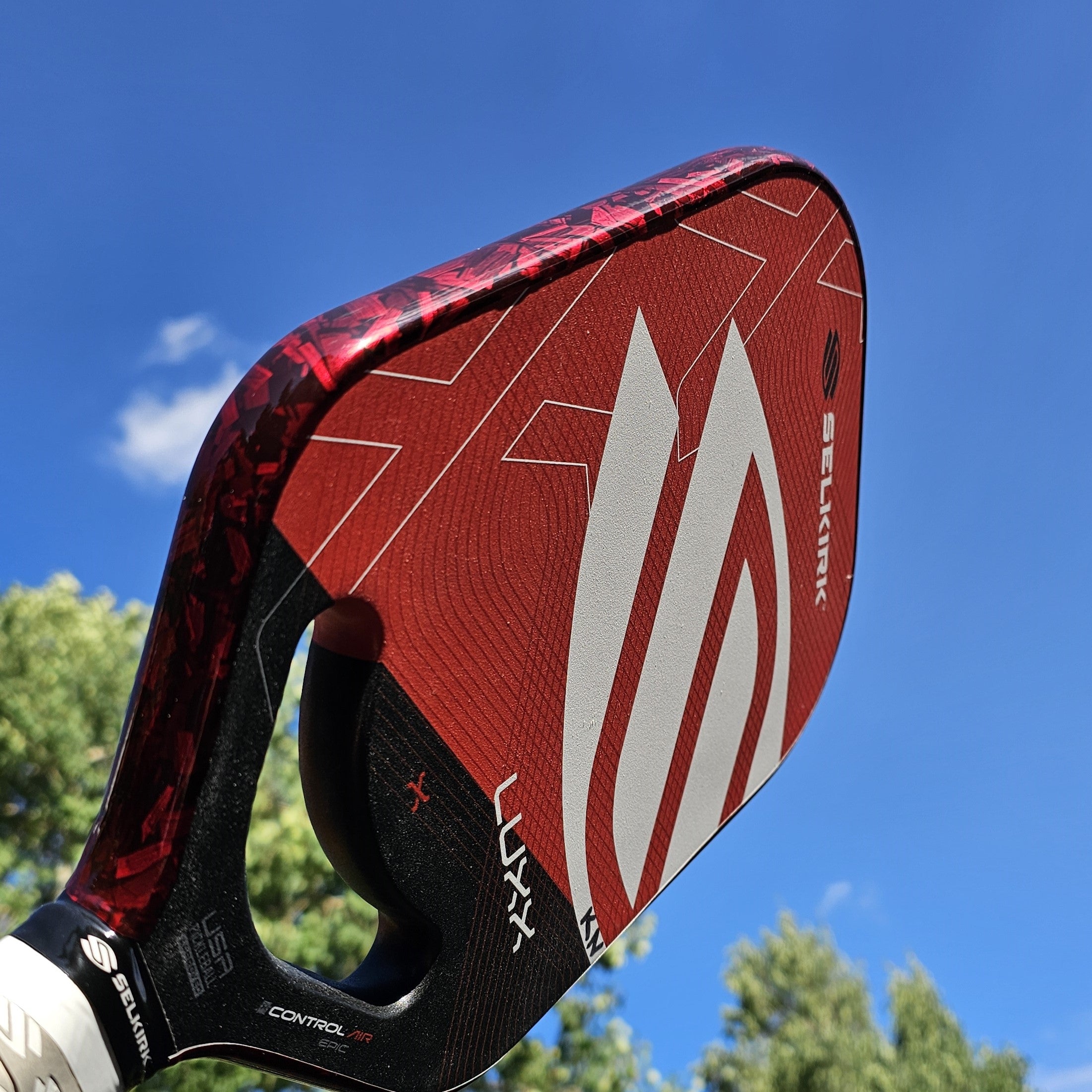 Selkirk Luxx pickleball paddle with red forged carbon edge tape