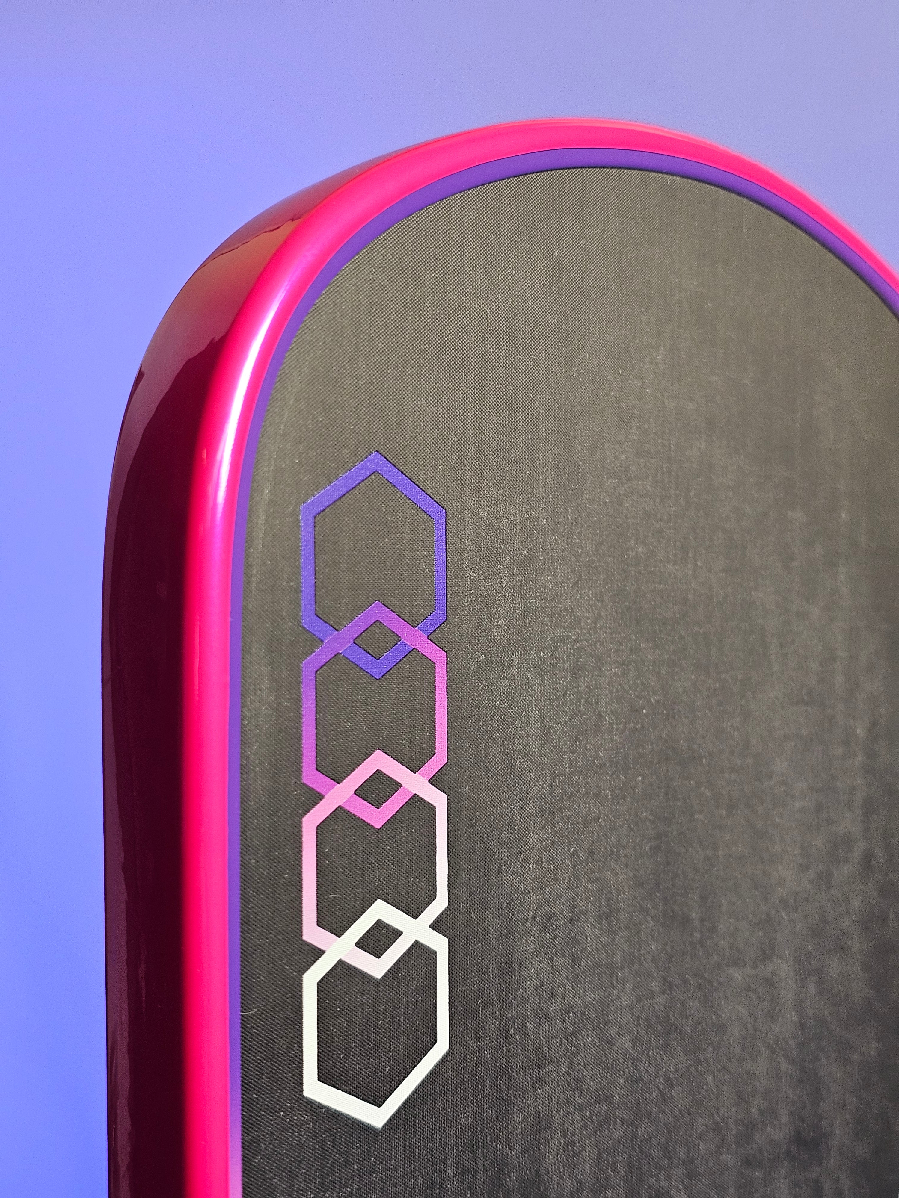 Close-up of a 11Six24 pickleball paddle with Hot Pink/Magenta edge tape