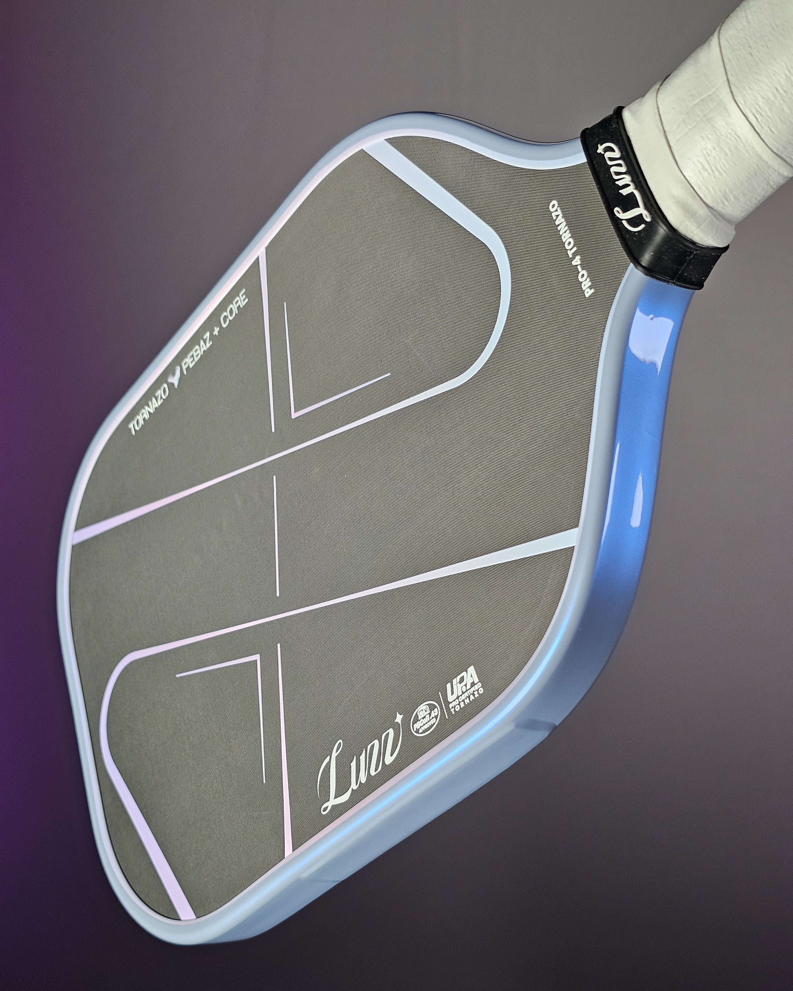 Close-up of a Luzz Tornazo pickleball paddle with Banzai Pickleball Ultimate Edge tape in Grey/Blue color