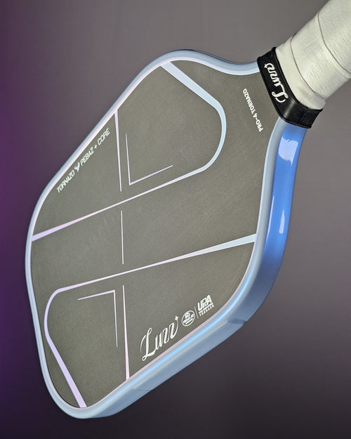 Close-up of a Luzz Tornazo pickleball paddle with Banzai Pickleball Ultimate Edge tape in Grey/Blue color