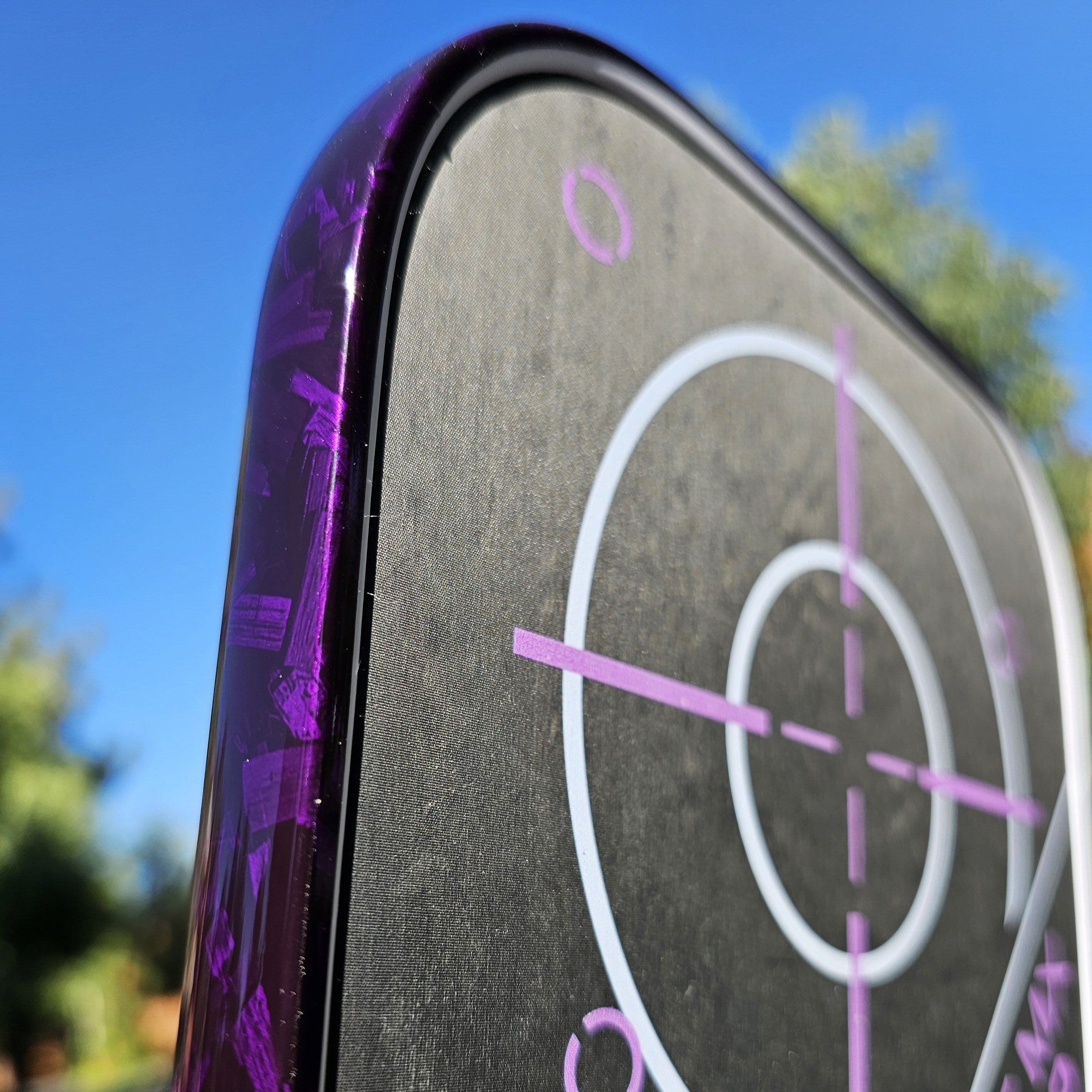 Close-up of Engage pickleball paddle with purple forged carbon edge tape