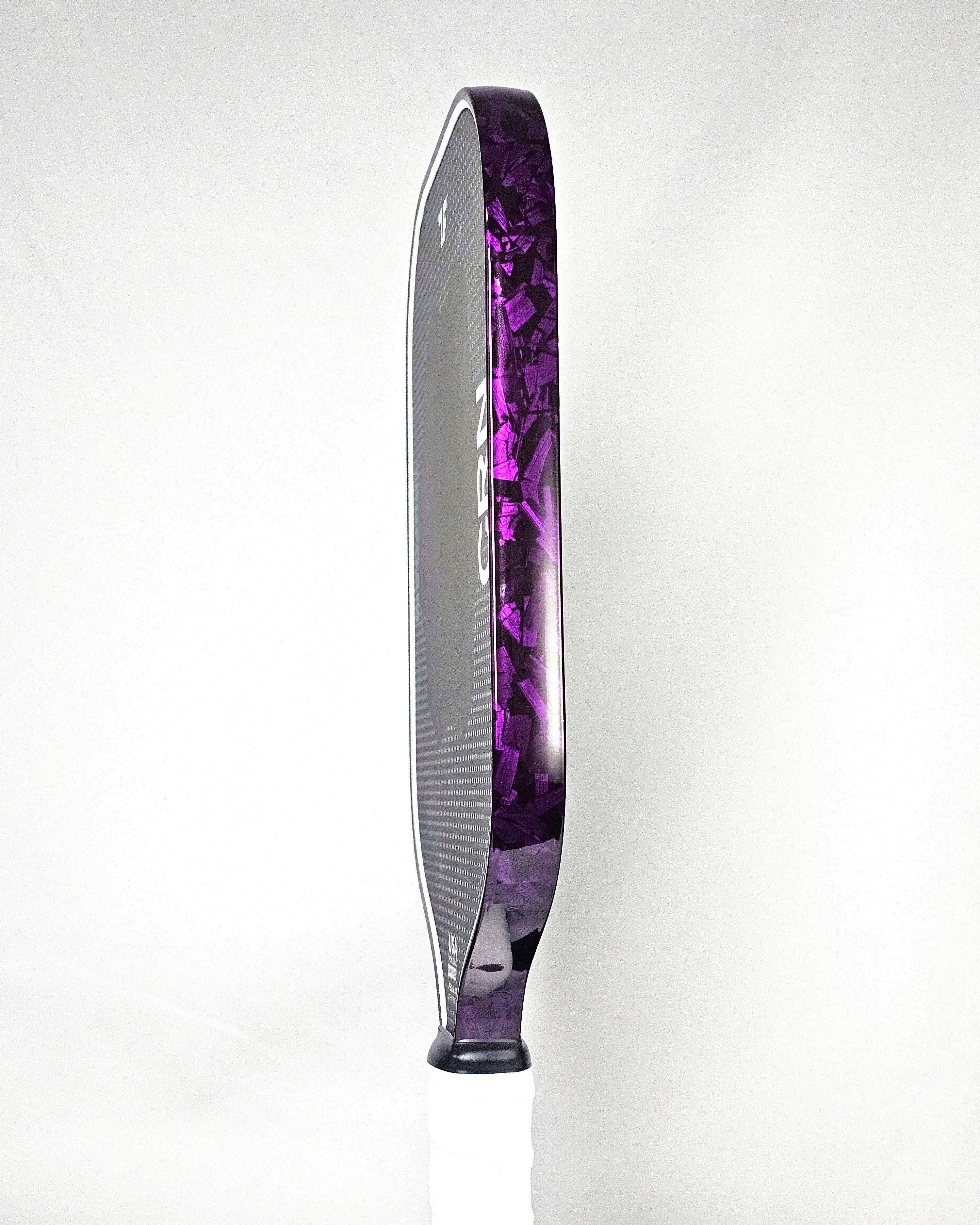 Pickleball paddle with purple forged carbon edge tape