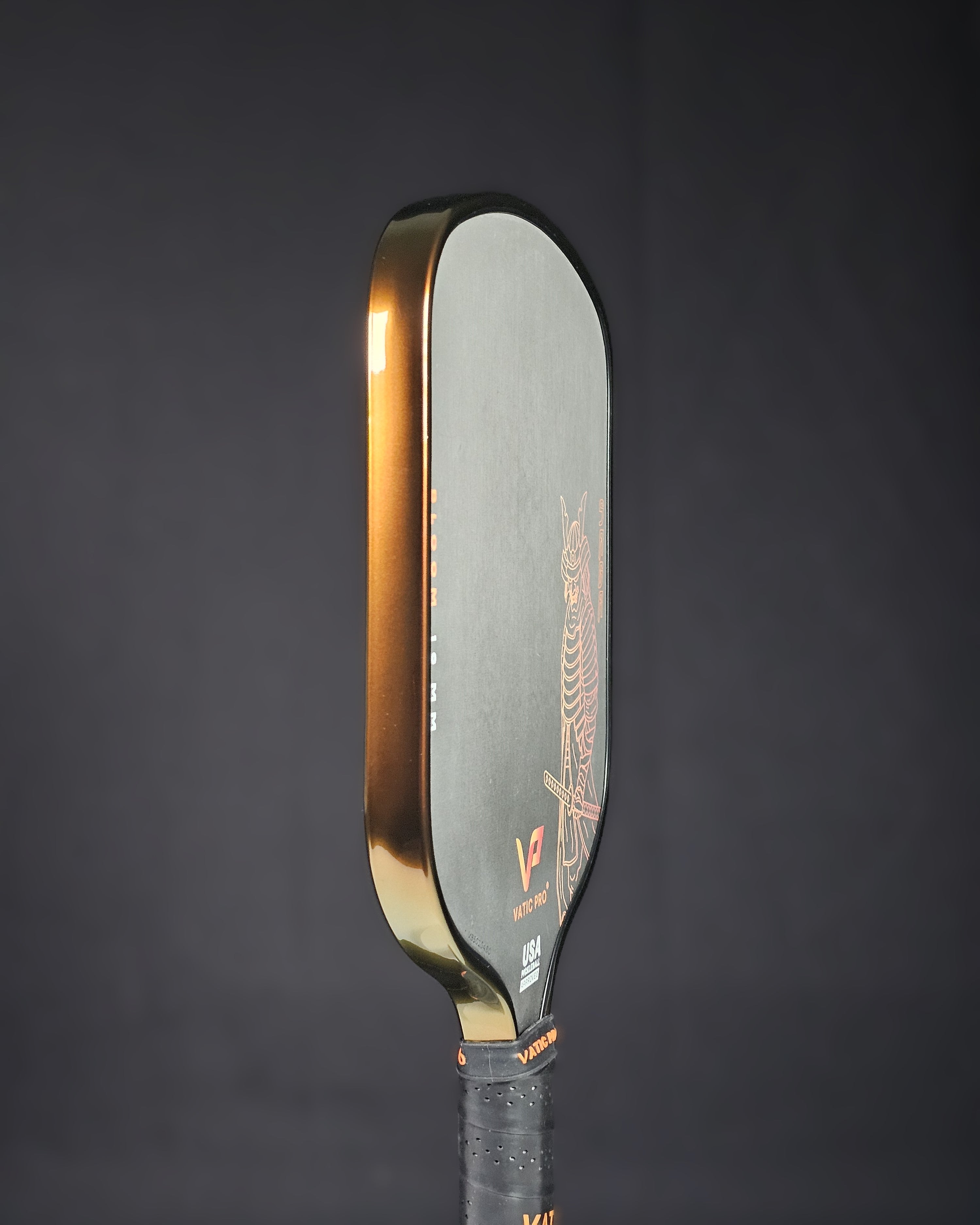 Vatic Pro pickleball paddle with Bronze color shift edge tape against a black background