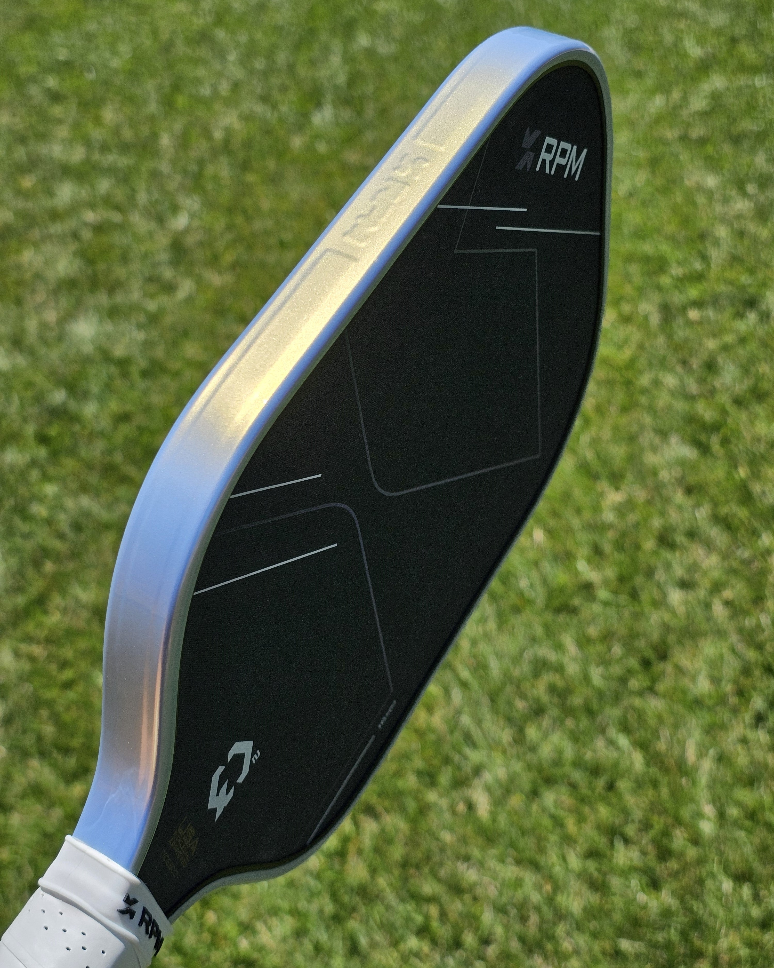 RPM pickleball paddle with platinum and gold colored protective edge guard tape