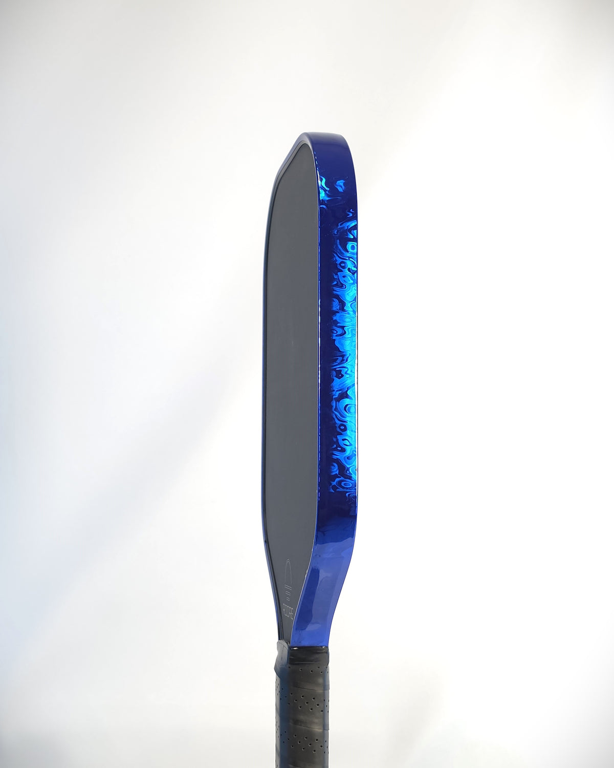 A side view of a pickleball paddle with a Blue Damascus edge tape installed shown against a white background