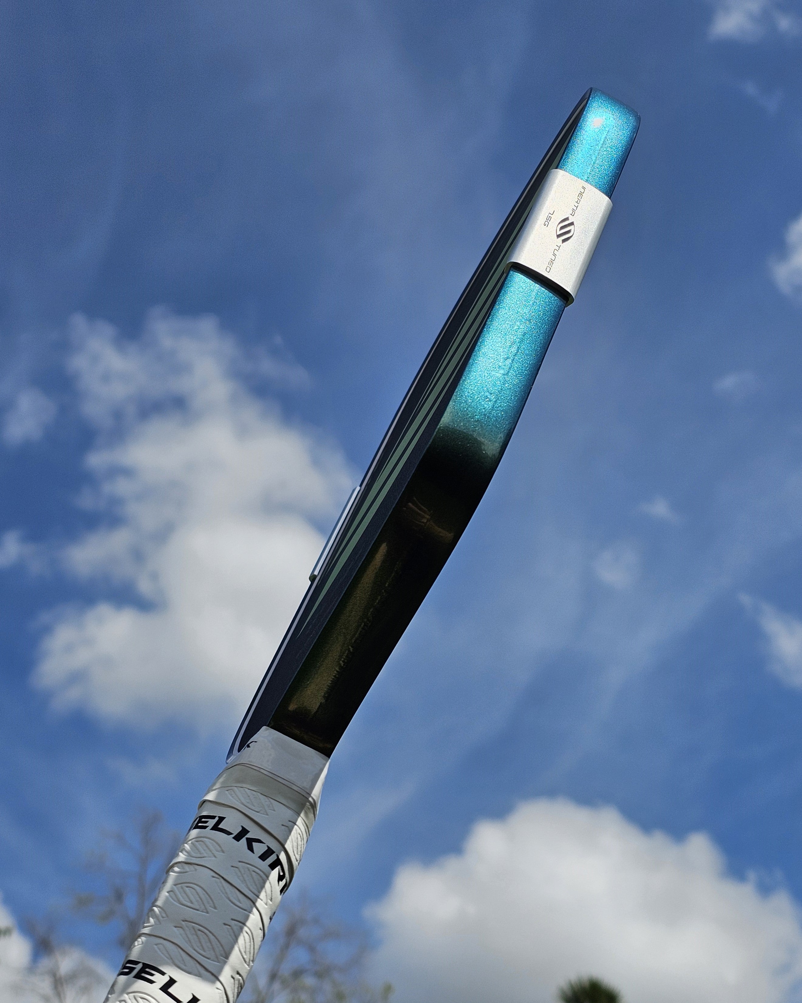 Close-up of a Selkirk Boomstik edge guard with Green/Gold/Blue color shift edge tape installed