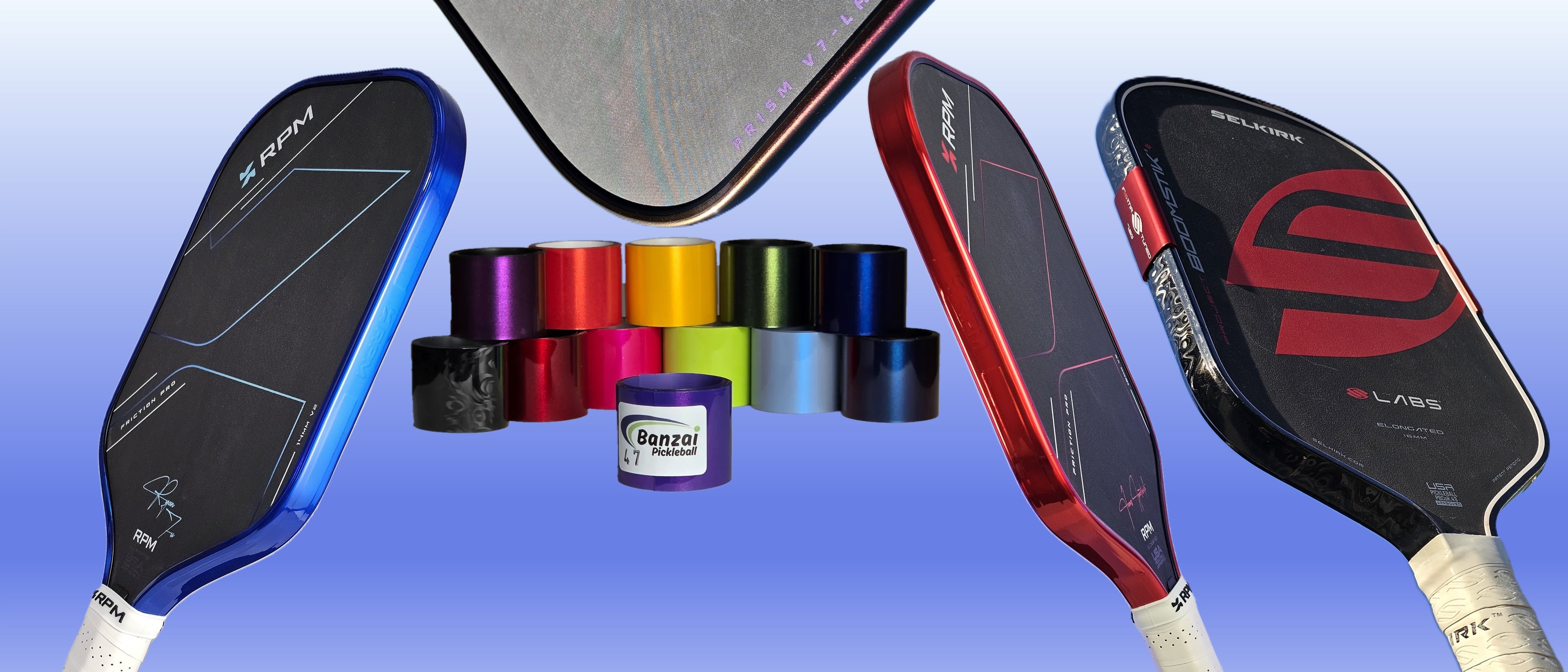 Three pickleball paddles in blue, red, and black are displayed alongside a row of colorful edge tape rolls on a blue gradient background. 