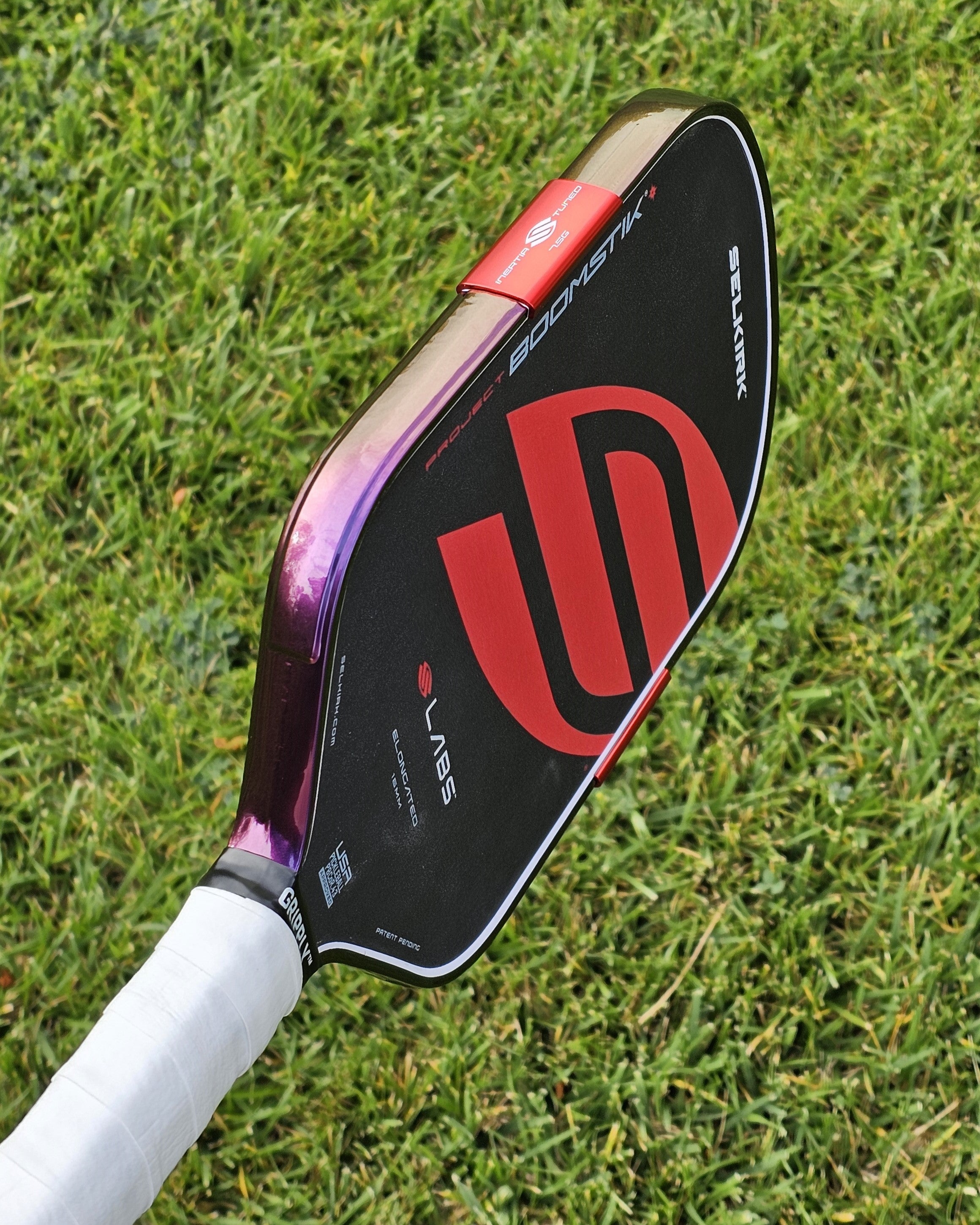 Selkirk Boomstik pickleball paddle with Indigo Sunset Color Shift edge tape installed