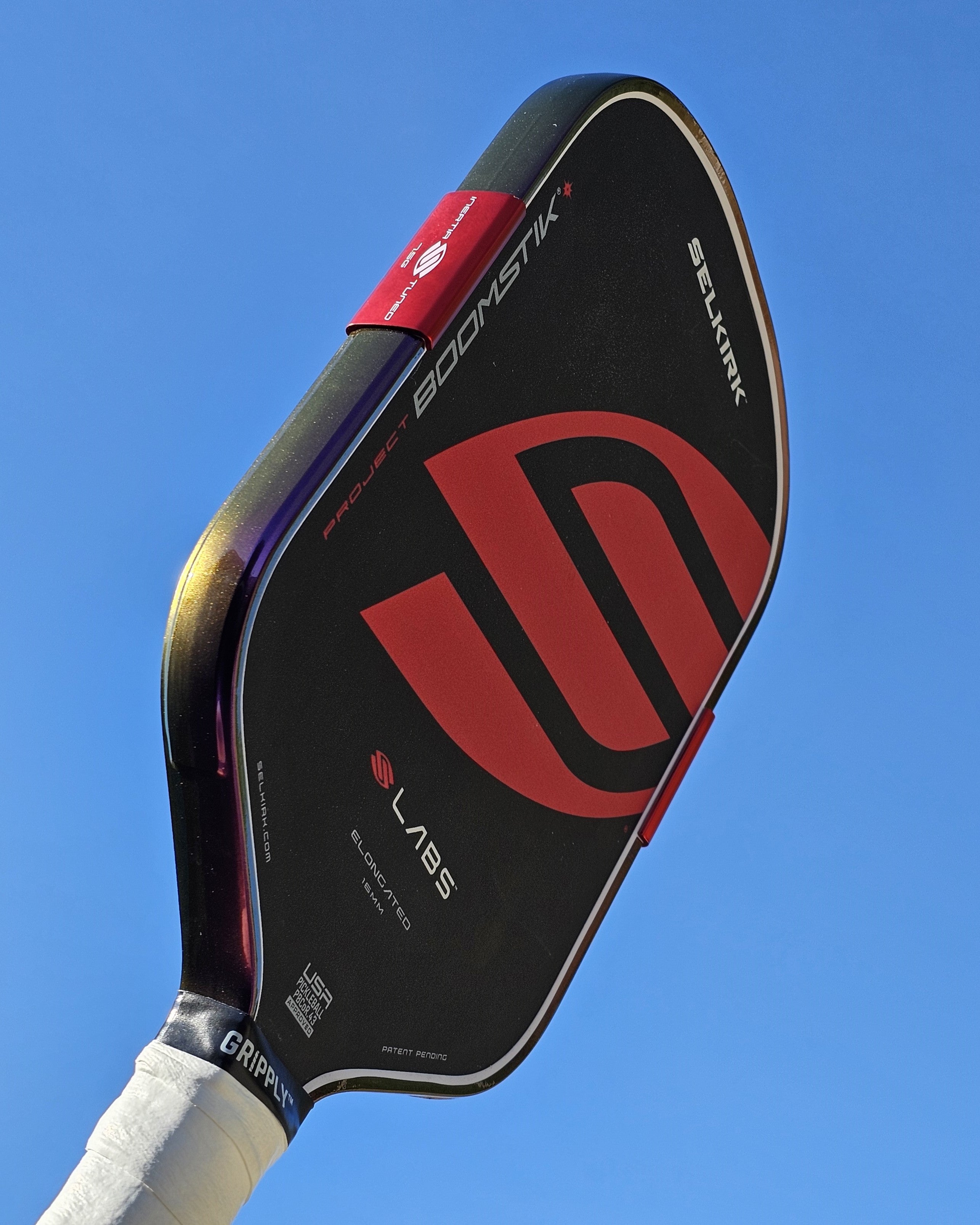 Pickleball paddle with Indigo Sunset Color Shift edge tape installed