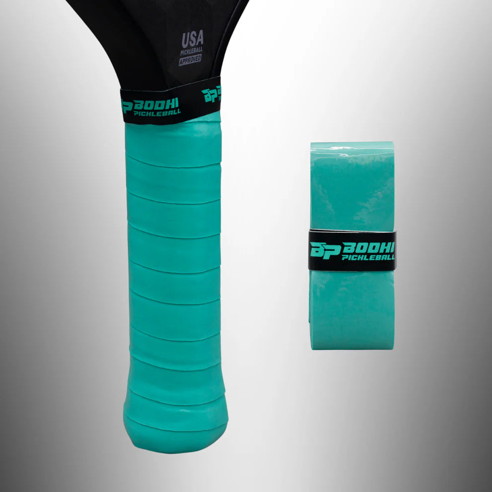 Teal pickleball overgrip with BODHI branding on a gray background