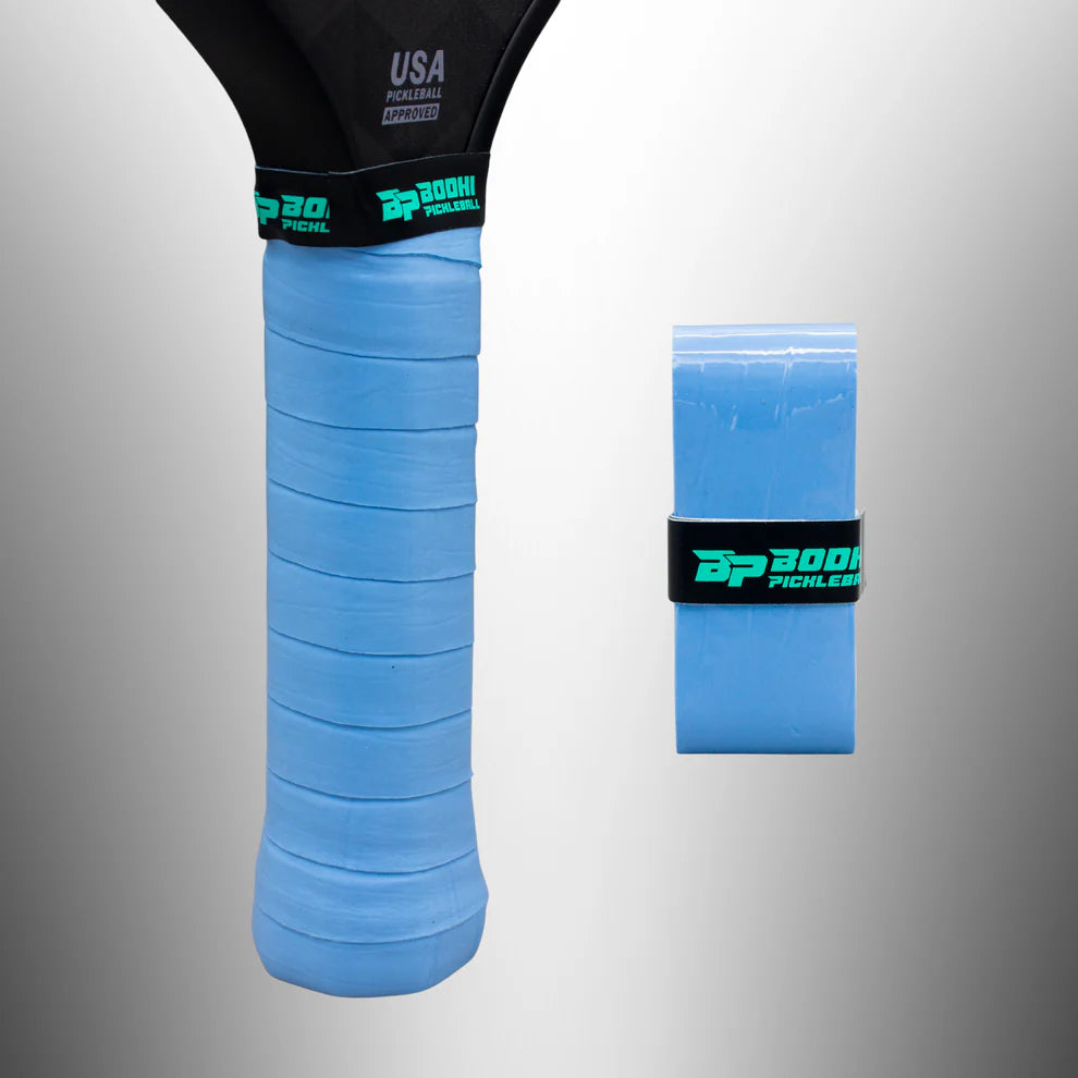 Blue BODHI pickleball overgrip on a gray background