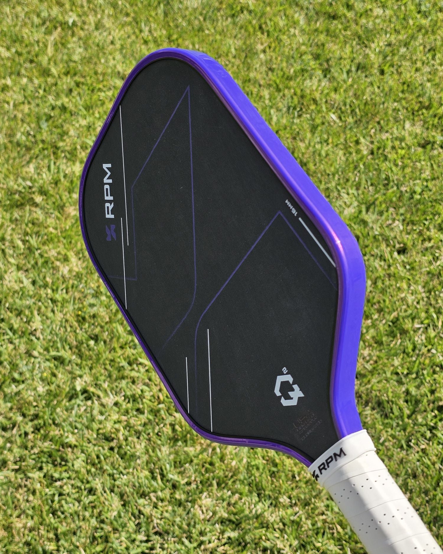 RPM Q2 pickleball paddle with purple Banzai Pickleball edge tape installed.