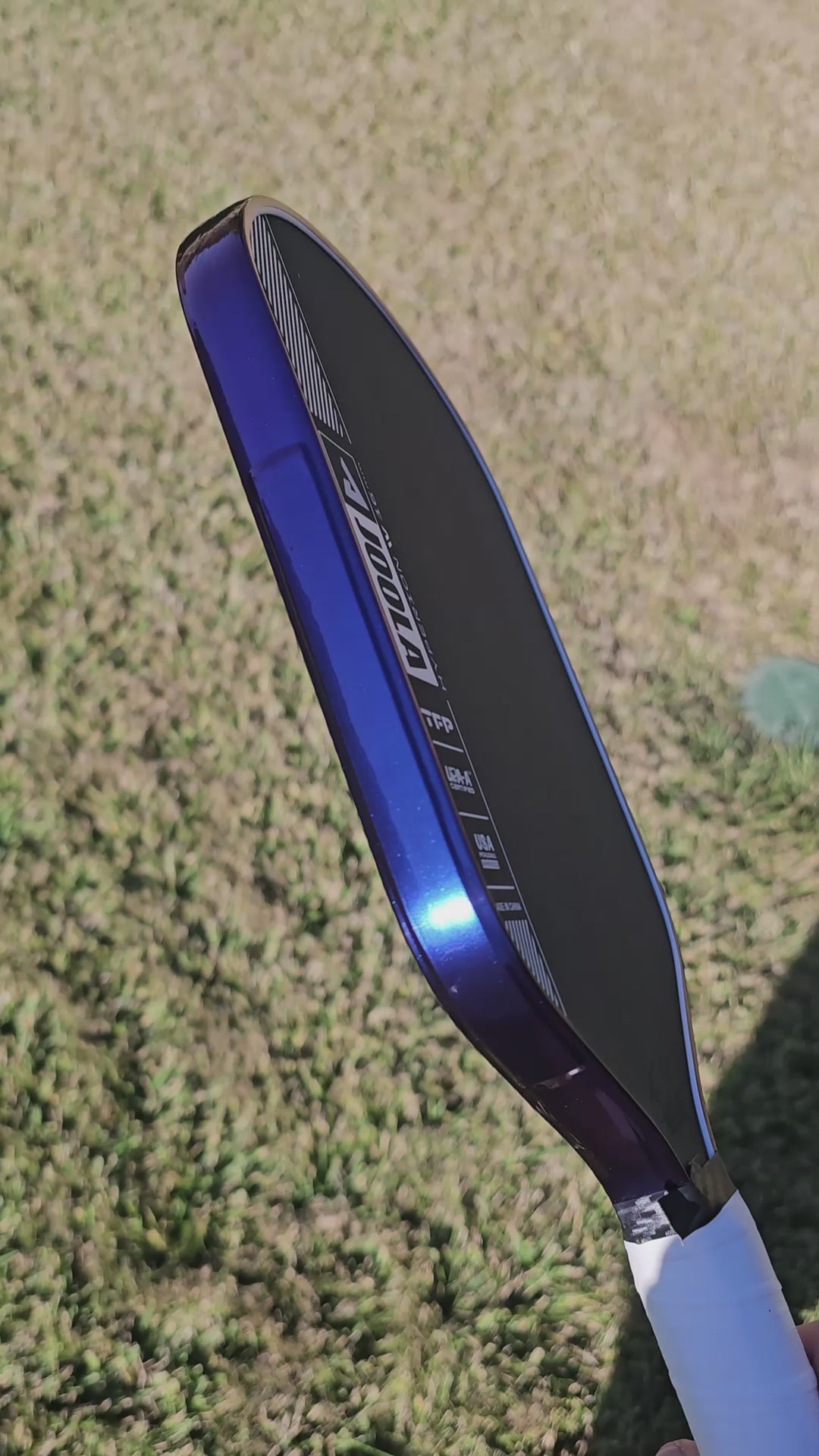Video clip of Joola Hyperion pickleball paddle with Blue/Purple color shift edge tape showing color shifting effect from blue to purple