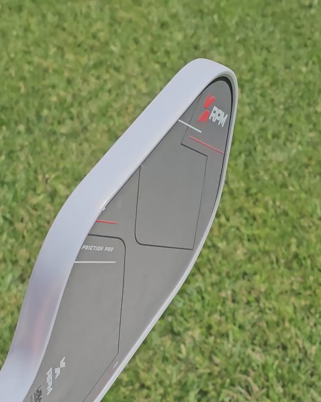 video clip showing a pickleball paddle with  two different shades of white/gold edge tape for comparison