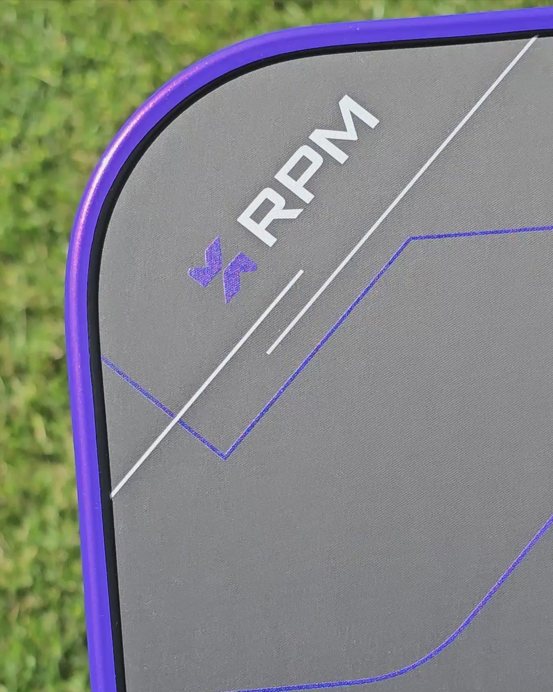 video clip of an RPM Q2 pickleball paddle showing an installed purple candy metallic edge tape