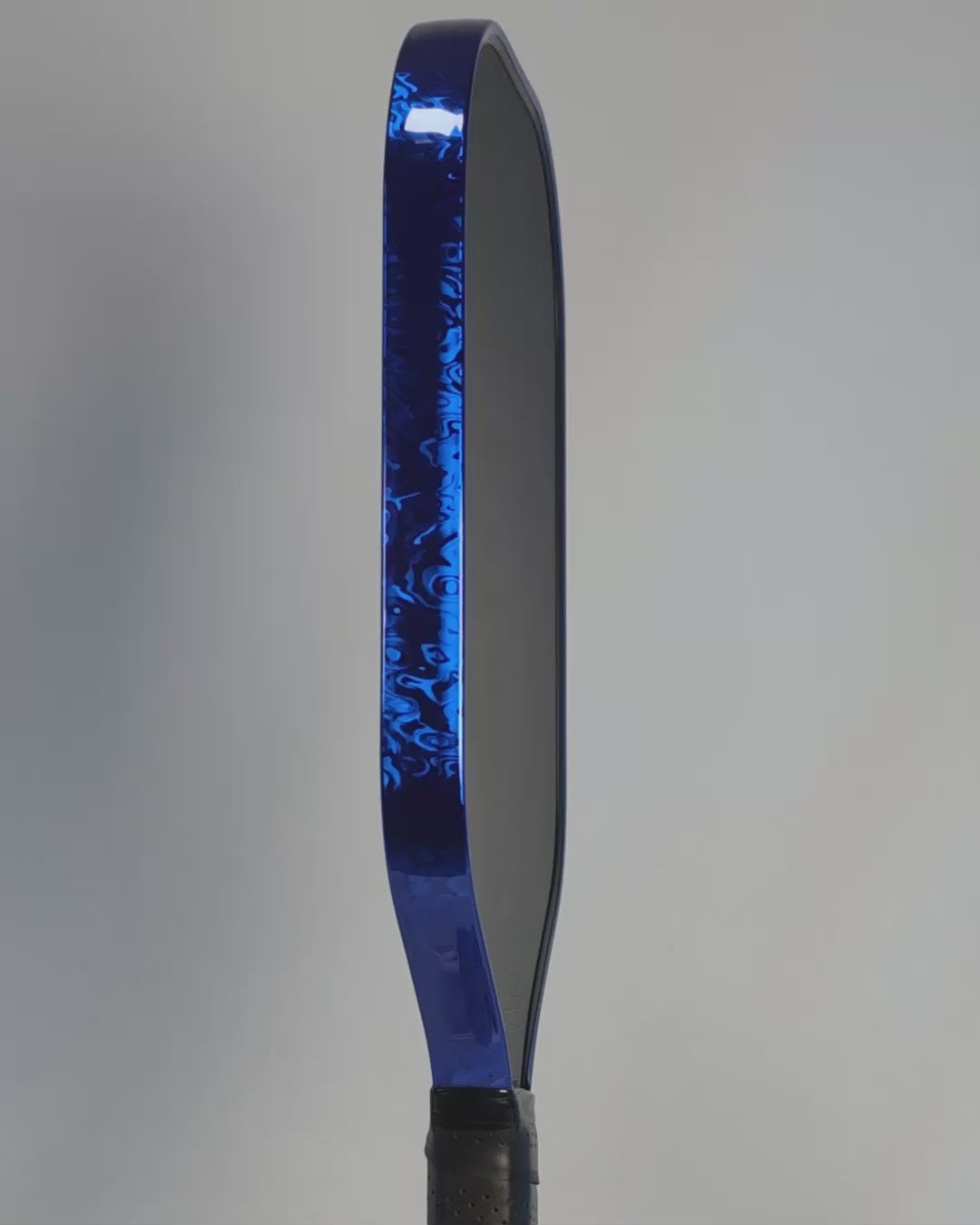 A video clip showing a rotating pickleball paddle with Blue Damascus protective edge guard tape.